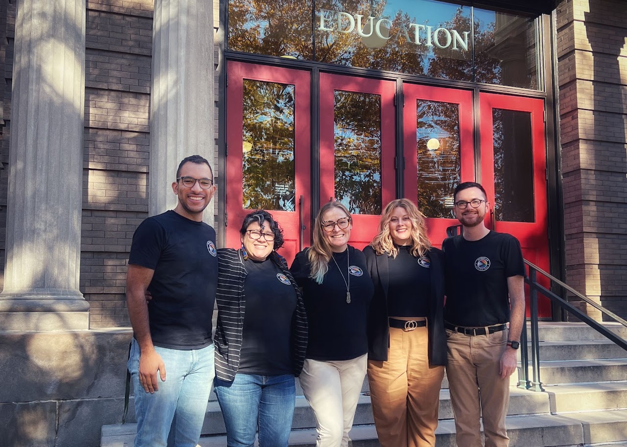Ben and four colleagues smiling on the front steps of the UW–Madison School of Education building